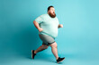 Overweight man running on blue background. Overweight and weight loss concept. Generative AI