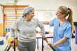 © Robert Kneschke - Physiotherapist assisting elderly woman in movement therapy at rehab center
