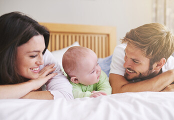 Poster - Mother, father and baby relax on bed for love, care and fun quality time together at home. Happy family, parents and newborn bonding in bedroom for support, happiness or nurture childhood development