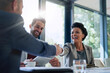 canvas print picture - Meeting, partnership and business people shaking hands in the office for a deal, collaboration or onboarding. Diversity, professional and employees with handshake for agreement, welcome or greeting.