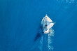 Leinwandbild Motiv Wave and sail yacht on the sea as a background. .Sea and waves from top view. Blue water background from top view. Top view from drone. Summertime vacation. Travel image