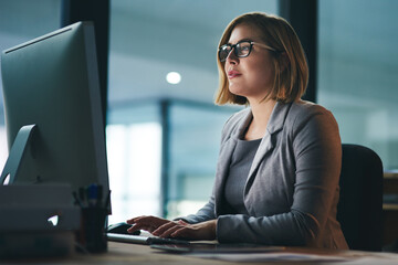 Poster - Computer, typing and business woman in office working late on project at night alone. Desktop, professional and female person writing email, report or planning, reading and overtime for deadline.