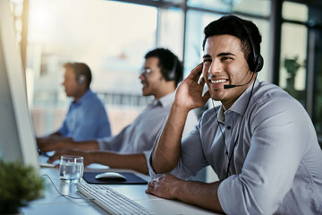 Poster - Callcenter agent, smile and man in office consulting with advice, help and happiness at desk. Happy phone call, conversation and service, customer support consultant speaking on headset at crm agency