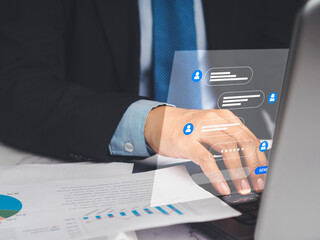 Businessman typing on a keyboard laptop with live chat chatting on application communication digital media websites and social network
