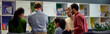 © Friends Stock - Rear view of multiracial business people communicating, sharing ideas and working together in the modern office or coworking space