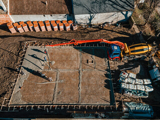 Wall Mural - Aerial view of a machine concreting foundation on a construction site.
