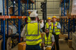© visoot - Portrait of warehouse workers are meeting together,Group of multicultural logistics employees working as a team in a large distribution centre.