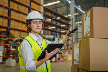 Aufkleber - Warehouse worker checking and loading or unloading boxes in a large distribution warehouse.