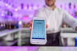 © ADDICTIVE STOCK - Crop bartender offering POS machine to pay for order