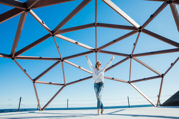 Wall Mural - a woman a stands at a large wooden structure walk