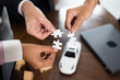 © NVB Stocker - Group of diverse business people assembling jigsaw puzzle. Unity and teamwork concept