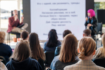 Canvas Print - Unrecognizable speakers doing presentation on stage for group of participants