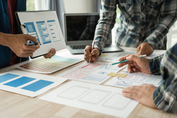 group of asian creative team programing designers participate in all phases of the ux design.