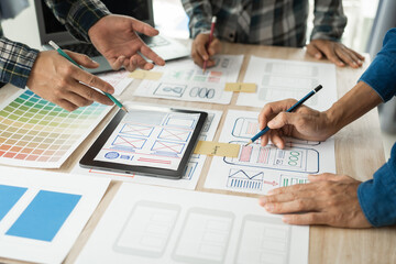 Wall Mural - group of asian creative team programing designers participate in all phases of the ux design.