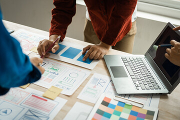 Wall Mural - group of asian creative team programing designers participate in all phases of the ux design.