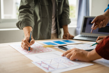 Wall Mural - group of asian creative team programing designers participate in all phases of the ux design.