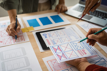Wall Mural - group of asian creative team programing designers participate in all phases of the ux design.
