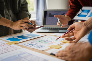 Wall Mural - group of asian creative team programing designers participate in all phases of the ux design.