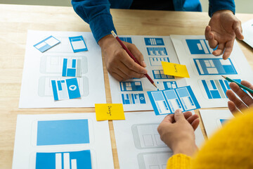 Wall Mural - group of asian creative team programing designers participate in all phases of the ux design.