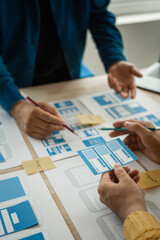 Wall Mural - group of asian creative team programing designers participate in all phases of the ux design.