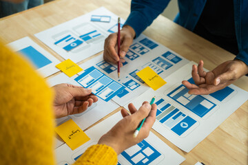Wall Mural - group of asian creative team programing designers participate in all phases of the ux design.