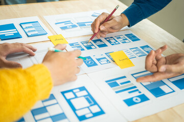 Wall Mural - group of asian creative team programing designers participate in all phases of the ux design.