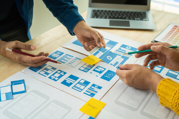 Wall Mural - group of asian creative team programing designers participate in all phases of the ux design.