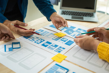 Wall Mural - group of asian creative team programing designers participate in all phases of the ux design.