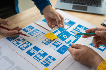 Wall Mural - group of asian creative team programing designers participate in all phases of the ux design.