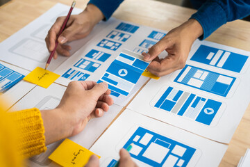 Wall Mural - group of asian creative team programing designers participate in all phases of the ux design.