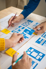 Wall Mural - group of asian creative team programing designers participate in all phases of the ux design.