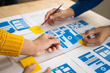 Wall Mural - group of asian creative team programing designers participate in all phases of the ux design.