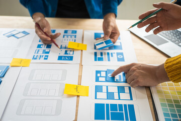 Wall Mural - group of asian creative team programing designers participate in all phases of the ux design.