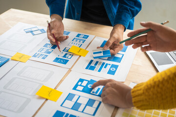 Wall Mural - group of asian creative team programing designers participate in all phases of the ux design.