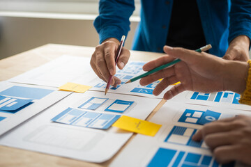 Wall Mural - group of asian creative team programing designers participate in all phases of the ux design.