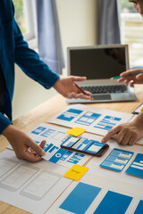 Wall Mural - group of asian creative team programing designers participate in all phases of the ux design.