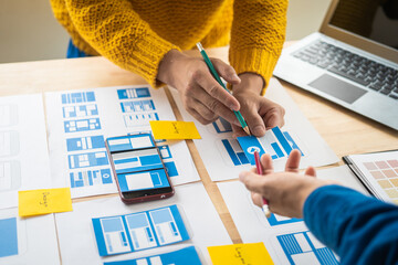 Wall Mural - group of asian creative team programing designers participate in all phases of the ux design.