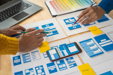 Wall Mural - group of asian creative team programing designers participate in all phases of the ux design.