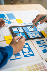 Wall Mural - group of asian creative team programing designers participate in all phases of the ux design.