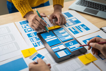 Wall Mural - group of asian creative team programing designers participate in all phases of the ux design.