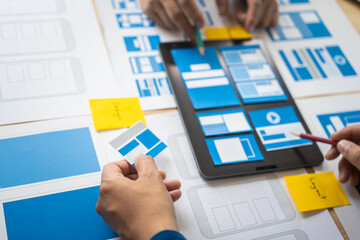 Wall Mural - group of asian creative team programing designers participate in all phases of the ux design.