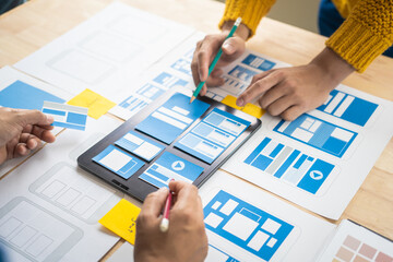 Wall Mural - group of asian creative team programing designers participate in all phases of the ux design.