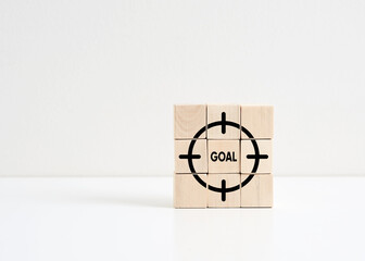 Wall Mural - business goal achievement and planning. the word goal on wooden cubes with target symbols.