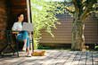 © boomeart - Freelancer woman rent tiny house and continue working outdoors