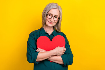 Poster - Portrait of sweet lovely person closed eyes arms hold hug paper heart card isolated on yellow color background