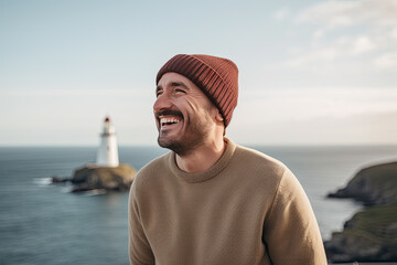 Traveler on background of lighthouse by sea. Portrait of a bearded scientist man with Lighthouse Generative AI