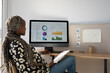 © Milles Studio/Stocksy - Black pregnant economist working with diagrams