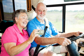 Senior couple using GPS to navigate their vacation motor home.