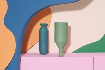 Stylish empty ceramic vases on color background