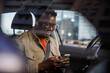 © Jovo Jovanovic/Stocksy - Young man messaging on mobile phone while sitting in car